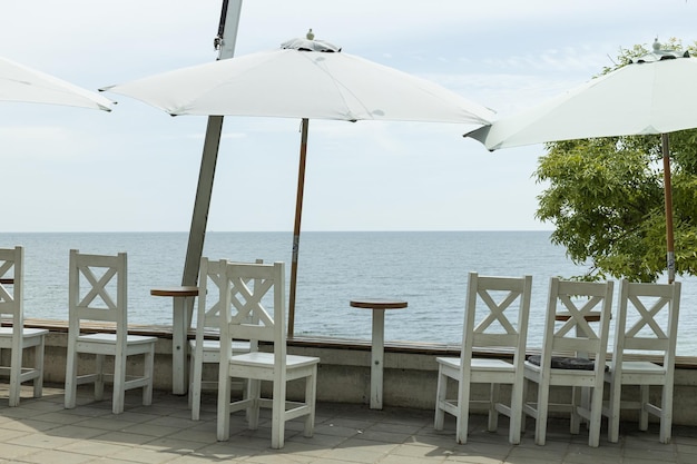 Tables with umbrellas on the beach cafes