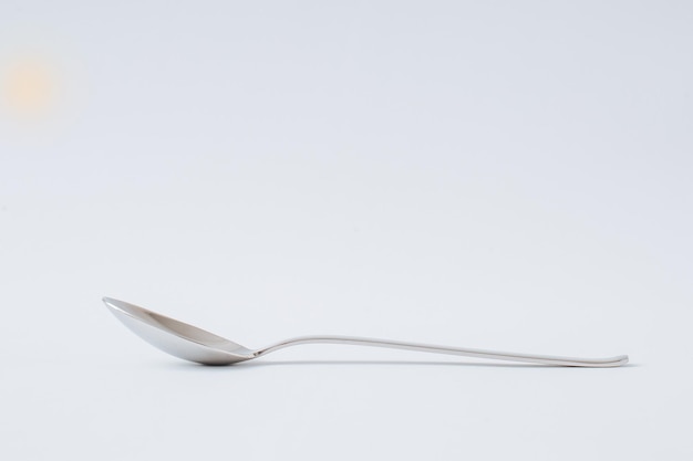 Tablespoon for food lies on a white background copy space