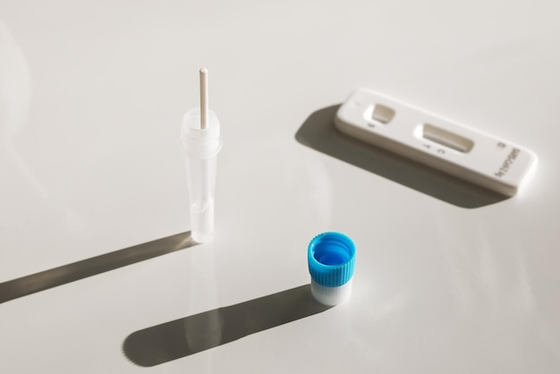 Tablet and covid and disease test kit on a white background