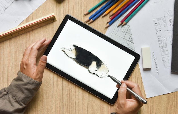 A tablet showing hand sketch the drawing of beagle dog with digital pens