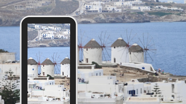 Tablet smartphone taking picture of Greek island