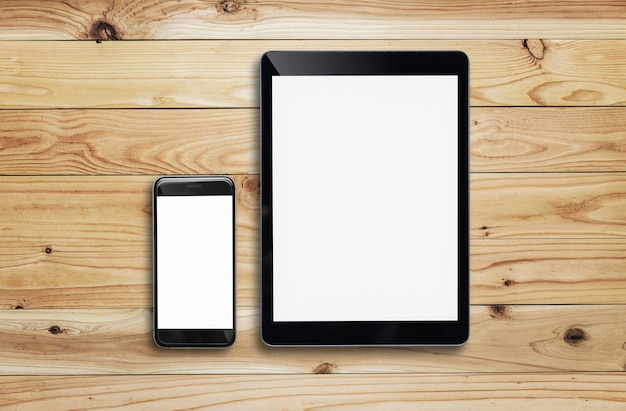 Tablet  and smartphone on wood table.