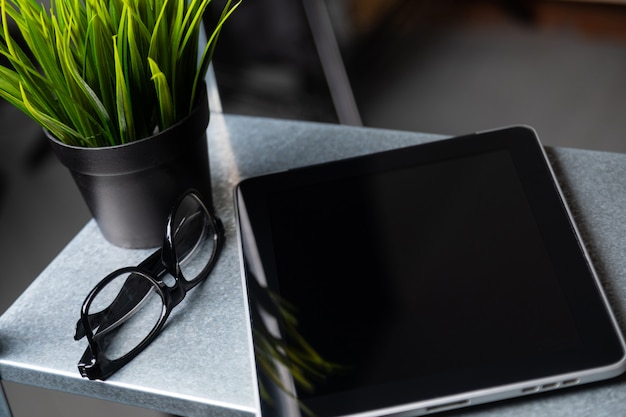 Tablet with a blank screen is on the table