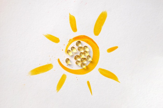 Tablets inside the drawing of the sun and the inscription vitamin D