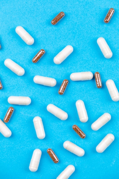 Tablets medicaments on a blue background with copy space