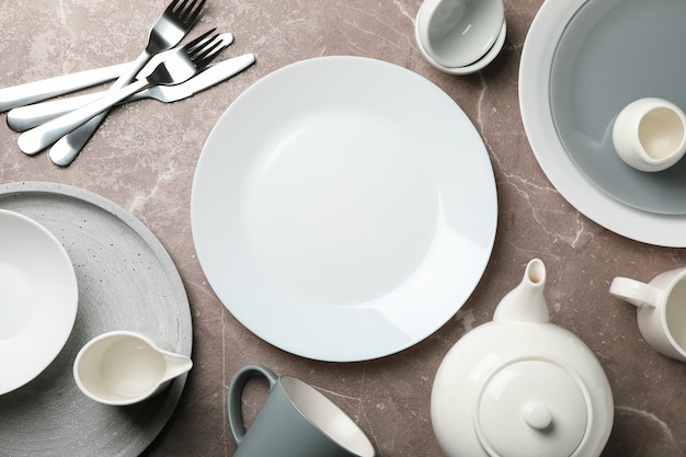 Tableware and cutlery on grey