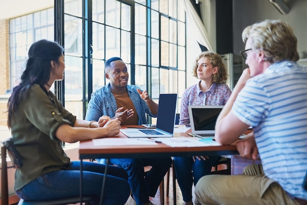 Photo tackling a project like the pros that they are shot of a diverse group of businesspeople having a meeting in a modern office