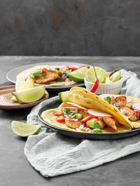 Tacos with chicken, vegetables and lime on the table. Copy space.