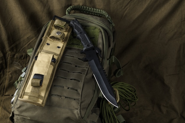 Photo tactical combat knife on a backpack