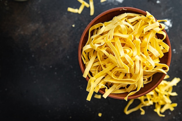 tagliatelle raw pasta durum wheat fresh portion ready to eat meal snack on the table copy space