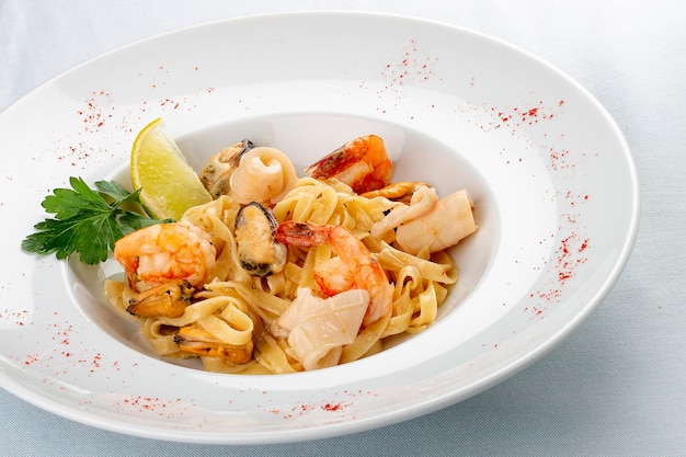 Tagliatelle with seafood Italian traditional dish On a white background