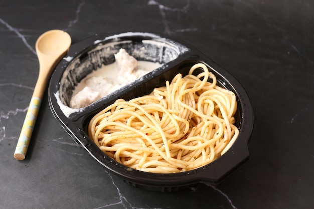 Take away cooked pasta in a plastic container