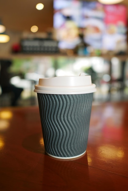 Take away paper coffee cup o on cafe table