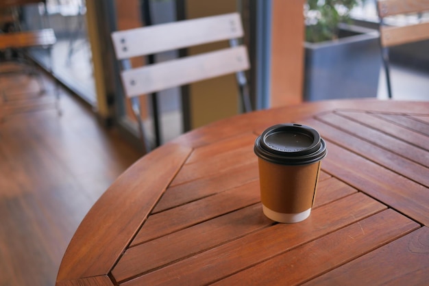 Take away paper coffee cup o on cafe table