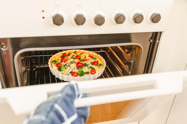 Take cooked cake out of oven