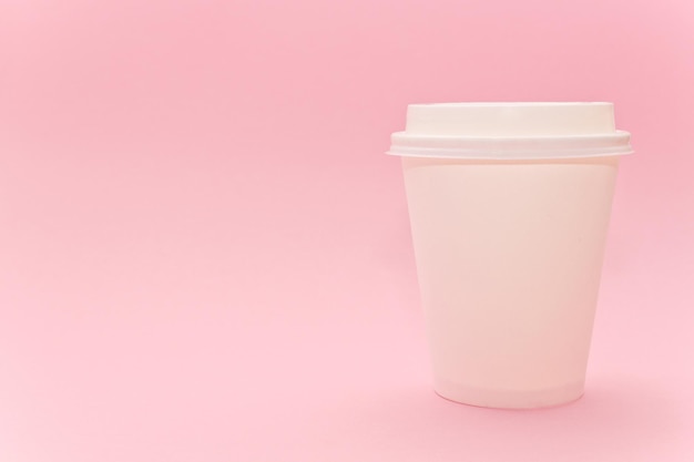 Takeaway papper coffee cup on pink background