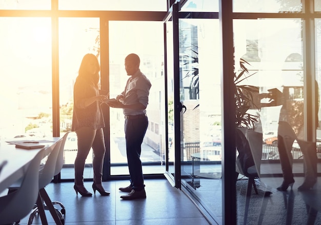 Taking business to the next level with ease Shot of two businesspeople having a discussion in an office