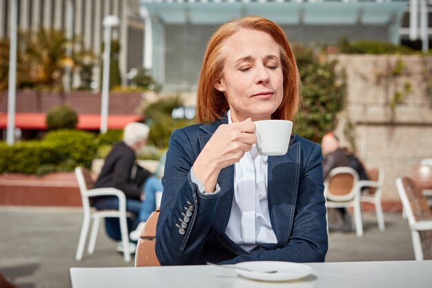 Photo taking a moment to recharge a successful middleaged businesswoman enjoys a peaceful coffee break