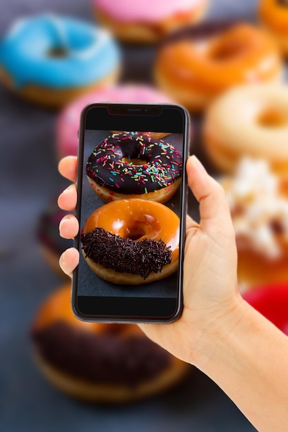 Taking photo of sweet doughnuts on gray stone background