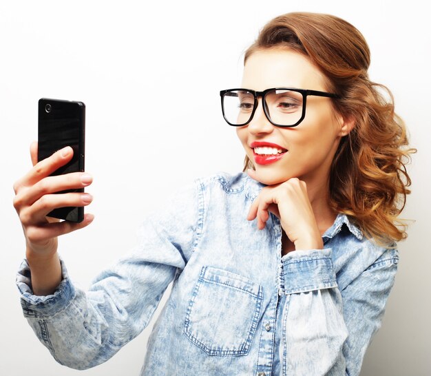 Taking picture. Smiling cheerful blond-haired woman doing selfie