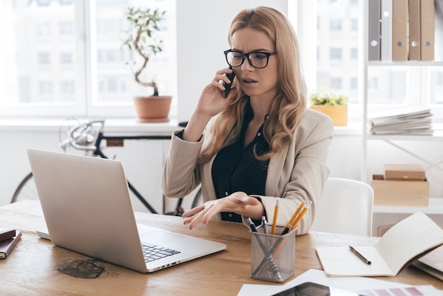 talking about details. gorgeous businesswoman in smart casual wear talking on the mobile phone 