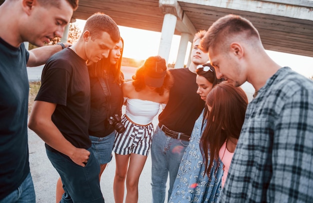 Talking and laughing Group of young cheerful friends having fun together Party outdoors