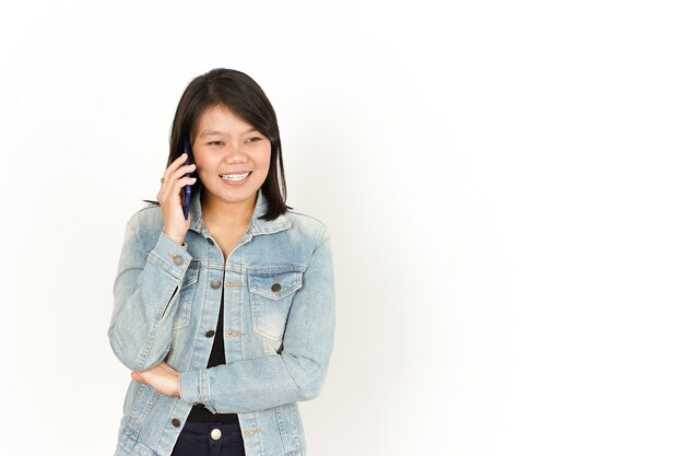 Talking on The phone of Beautiful Asian Woman Wearing Jeans Jacket and black shirt Isolated On White