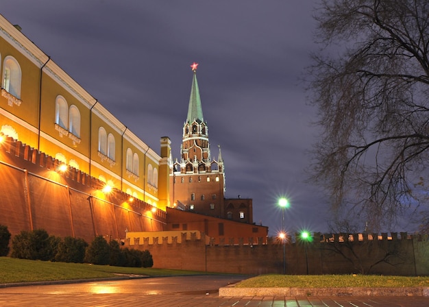 A tall building with a green roof and a red star on top.