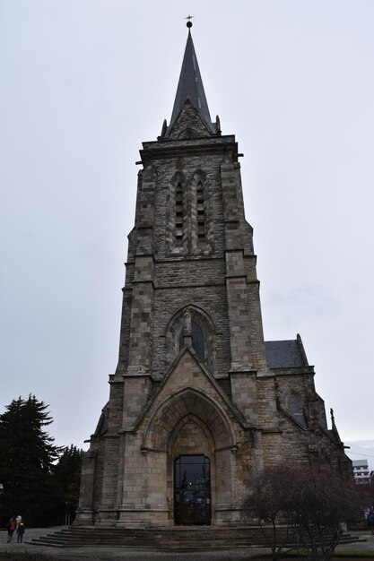 a tall church with a clock on the top of it