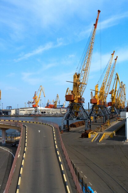 Tall cranes and big ships moored at the industrial sea port