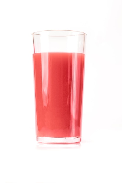 A tall glass with a pink strawberry or cherry juice drink on a white background