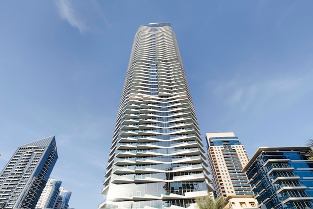 A tall residential skyscraper against the sky Looking up tall glass and steel highrise