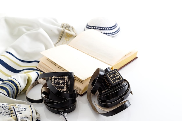 Tallit and tefillin and jewish Kippah yarmulke hat on white background