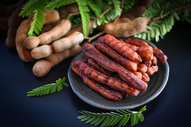 Tamarind sweet for food fruit ripe tamarinds on dark plate background Tamarind peel tropical fruits summer