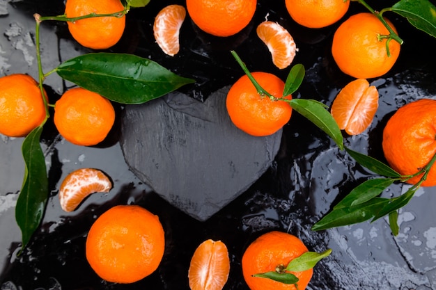 Tangerine around with black slate heart shaped.