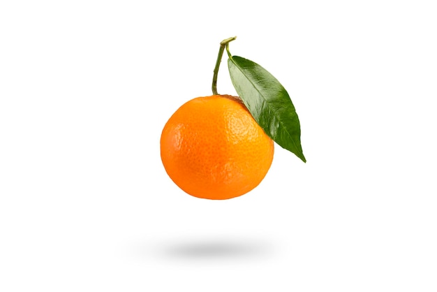 Tangerine with green leaf falls casting a shadow .Fresh tangerine on a white isolated background. Texture of mandarin close-up.