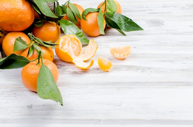 Tangerines clementine with leaves on a wooden table. 