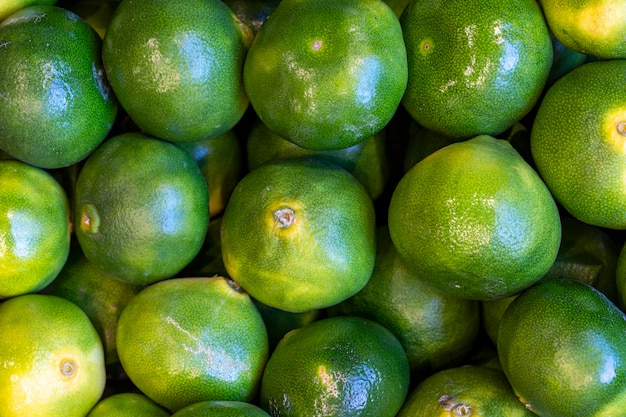 Tangerines on the market counter Pile of ripe tangerines