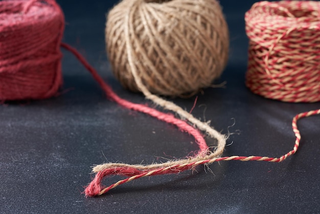 A tangle of multi-colored threads on a dark background.