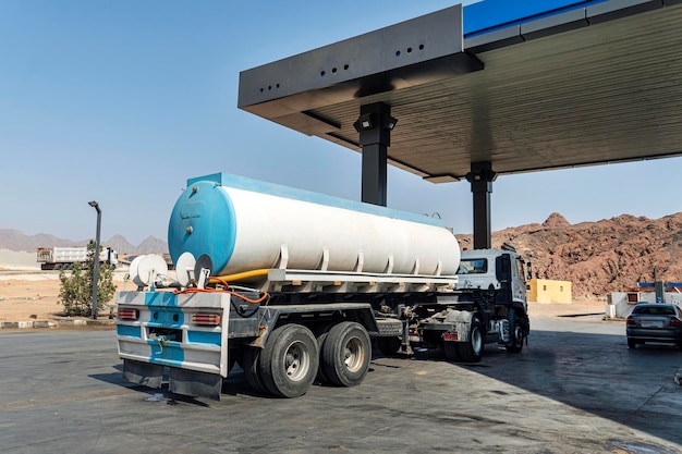 Tanker gas truck delivering fuel at service station fuel delivery to the gas station Fuel industry