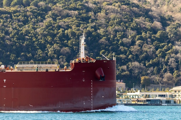 Tanker ship pass through the Bosporus with Bosphorus Bridge in Istanbul Turkey or Turkiye Bosphorus strait connecting Europe to Asia Tanker ship in Istanbul Turkey