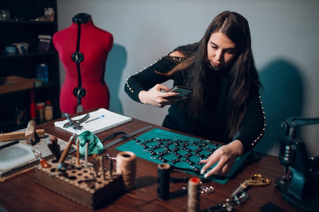 Tanner woman making leather goods on workshop Working process of leather craftsman