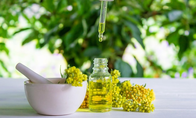 Tansy essential oil in a beautiful bottle on the table