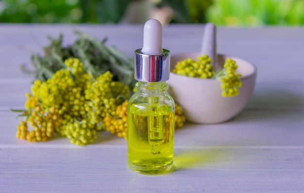 Tansy essential oil in a beautiful bottle on the table