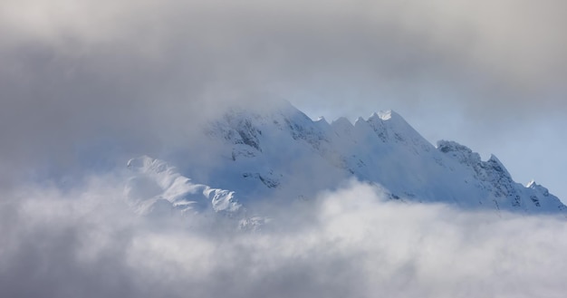 Tantalus Range covered in Snow and Clouds during Winter Season