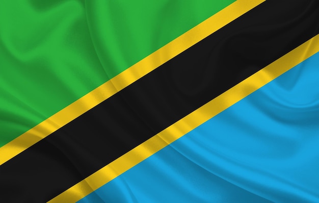 Tanzania country flag on wavy silk fabric background panorama - illustration