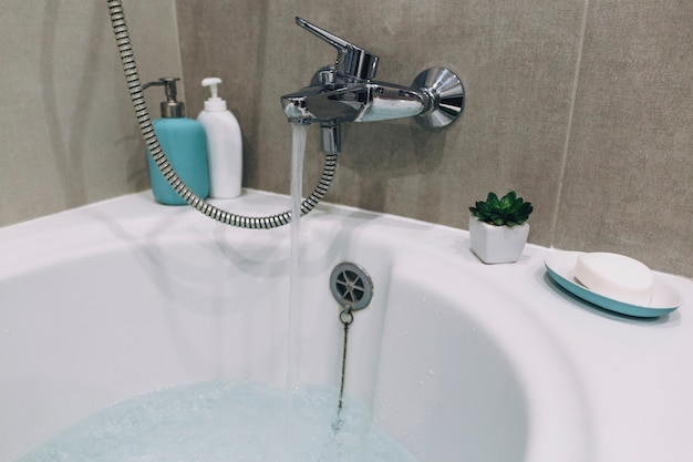 Tap filling bathtub with water