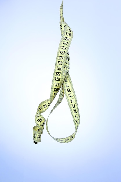 Tape measure noose on blue background diet concept