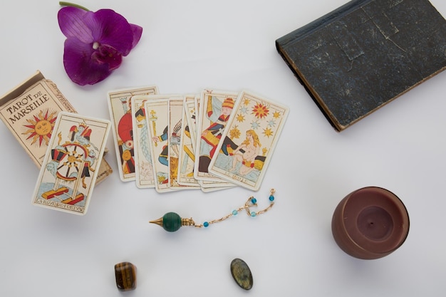 Photo tarot cards with old book and candle