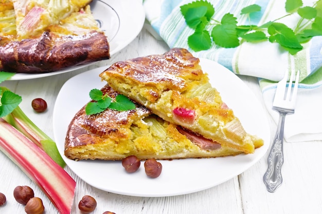 Tart with rhubarb and nut cream in plate on board